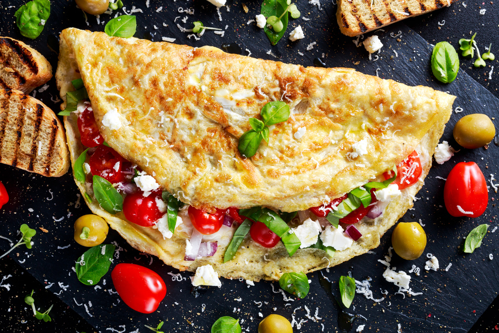 Vegetables Omelette with tomatoes, basil, greek cheese, parmesan, olives, toast.